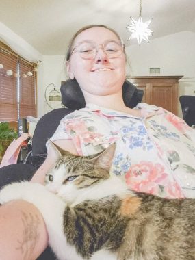 allergies | SMA News Today | Brianna takes a selfie with her cat, Rey, who's curled up on her lap.