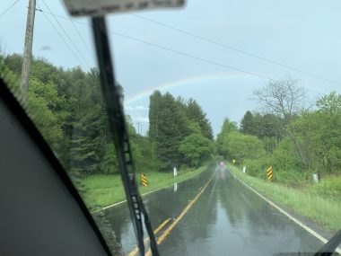 signs from above | SMA News Today | photo looking out at a highway, with a rainbow in the distance