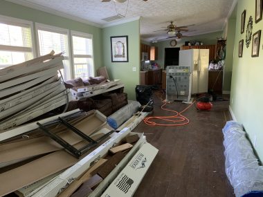 night before first day of school | SMA News Today | A long, green apartment is in chaos as it is being renovated. All kinds of materials are stacked on the floor, appliances are scattered about, and an orange extension cord winds across the floor.